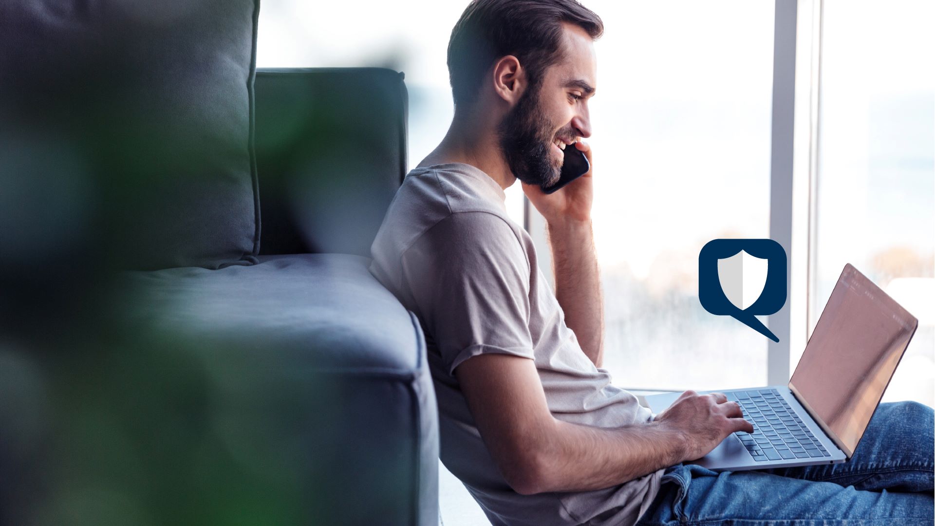 A man on the phone while on his laptop.